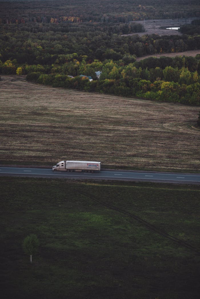 gallery-5 A lone truck travels through the scenic countryside road in Николаевка, Башкортостан, Russia.